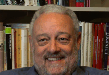 Haiti Since 1804: Critical Perspectives on Class, Power, and Gender Alt text: Split image featuring the cover of the book "Haiti Since 1804: Critical Perspectives on Class, Power, and Gender" by Alex Dupuy on the left, with a distressed Haitian flag as background; and on the right, a grayscale portrait of a smiling man with a beard seated in front of a bookshelf filled with academic books.