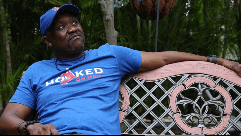 a sitting Haitian Man looking up